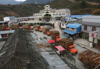 Trucks carrying logs wait to pass through Chinese customs in March 2006 in Pangwa, the capital of Kachin Special Region 1