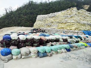 Bags of rare earth are piled up at a mine to be processed before being exported to China